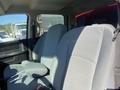Interior of a 2015 RAM 2500 showing the front seats with gray upholstery and a center armrest