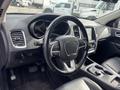 Interior of a 2015 Dodge Durango featuring a black steering wheel with controls and a modern dashboard display