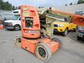 A 2009 JLG E300AJP aerial lift with a distinctive orange vertical mast and platform on wheels designed for elevating workers at height