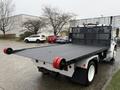 A 2019 Freightliner M2 flatbed tow truck with a black loading surface and red wheel straps at the rear
