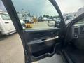 2015 RAM 1500 with the driver's door open showing the interior door panel and controls