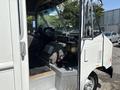 Interior view of a 2012 Ford Econoline with driver seat dashboard and various tools and equipment visible on the floor