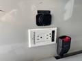 A wall-mounted electrical outlet with two standard sockets and a 12-volt outlet labeled 12 VOLTS 20 AMPS in a 2020 Mercedes-Benz Sprinter 2500