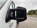 A 2023 RAM Promaster 3500 with a focus on its side mirror showcasing a black housing design and handle
