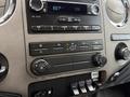 Dashboard controls of a 2019 Ford F-750 featuring a radio display climate control buttons and auxiliary switches