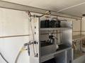 A 2008 Wells Industries Inc EW1422 is installed on a metal shelf with various hoses and fittings connected to it