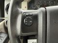 Close-up of the steering wheel controls of a 2008 Ford F-450 SD featuring buttons for setting cruise control with on off and resume options