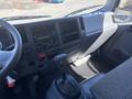 Interior of a 2022 Isuzu NQR showing the dashboard driver seat gear shift and control panel