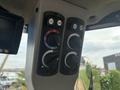 Control panel of a 2012 Caterpillar 980 featuring knobs and buttons for adjusting various functions and settings