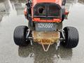 A 2012 Kubota F3680 with a distinct front grille and large rear tires positioned on wet ground