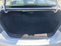 The image shows the empty trunk of a 2015 Hyundai Sonata with a dark interior and a smooth floor design