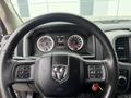 Steering wheel of a 2016 RAM 1500 with dashboard display showing speed and fuel indicators