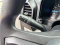 A close-up of the turn signal lever on the steering column of a 2020 Ford F-150 with various control settings visible