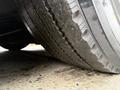 A close-up view of a worn tire of a 2016 Grande West Vicinity bus showing visible tread wear and dirt on the surface