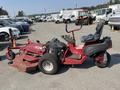 2017 Ferris lawn mower with a red body and black seat featuring a large cutting deck and rear tires designed for maneuverability