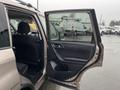 A 2016 Subaru Forester with the driver's side door open showing the interior seats and door panel