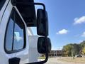 Close-up of a side mirror on a 2019 Freightliner M2 106 showing the curved black mirror and its mounting bracket