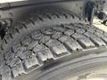Close-up of a heavily treaded tire on a 2008 International 4300 displaying wear and dirt accumulation on the surface