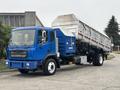 A blue 2017 Autocar Xpert dump truck with a silver open cargo bed angled for loading, featuring side compartments and a visible exhaust system