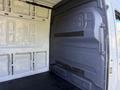 Interior view of a 2020 Mercedes-Benz Sprinter van showing bare walls and floor with a focus on the cargo area and its designed space for storage