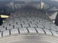 Close-up of a large tire on a 2009 Ford F-550 showcasing detailed tread patterns