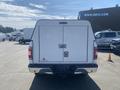 A white 2019 Ford F-150 with a truck bed cap and a rear double door at the back