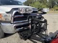 A 2013 RAM 5500 truck with a front-mounted snow plow attachment and two large headlights on top of the plow