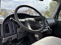 Interior view of a 2005 Freightliner M2 106 featuring a steering wheel and dashboard with various controls and gauges