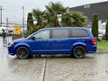 A blue 2020 Dodge Grand Caravan parked with sleek lines and black alloy wheels