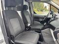 Interior view of a 2019 Ford Transit Connect featuring two fabric-covered front seats with a center console and dashboard visible