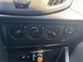 Dashboard control panel of a 2019 Ford Transit 350 featuring climate control knobs and a 12V power outlet