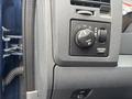 Control panel of a 2006 Dodge Ram 2500 featuring knobs for lights and cargo settings