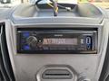 A Kenwood car stereo with a digital display reading NO DEVICE located in the dashboard of a 2018 Ford Transit-350