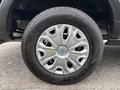 Close-up of a wheel from a 2020 Ford Transit 250 showing a silver alloy rim and a black tire with tread pattern visible