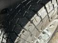 Close-up of a wet tire featuring a rugged tread pattern on a 2021 Chevrolet Express van