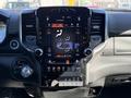 Interior view of a 2021 RAM 3500 with a large touchscreen display featuring climate controls and various vehicle settings