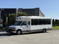 A white 2020 Chevrolet Express shuttle bus with a large front windshield and a flat roof designed for passenger transport