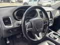 Interior view of a 2015 Dodge Durango showcasing the steering wheel dashboard and center console with controls and a touchscreen display