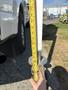 A measuring tape being held next to a 2018 Westland Travelaire showing the height measurement of the trailer's stabilization jack