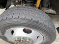 Close-up of a 2015 Ford F-550 tire showing tread pattern and rim with visible bolts