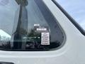 A close-up of the window of a 2013 International WorkStar showing a certificate of approval sticker with months listed from July to December