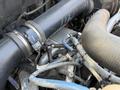 Close-up view of the engine components of a 2011 International 7500 showing hoses and pipes connected to the engine system