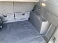A 2015 Ford Escape with a spacious rear cargo area featuring flat, carpeted flooring and side compartments