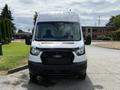 A white 2021 Ford Transit van with a black grille facing forward