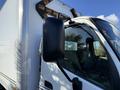A 2014 Hino 195 truck with a prominent side mirror and reflective components in the foreground