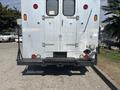 A 2008 Workhorse W62 delivery truck with a metal exterior and a rear loading platform featuring taillights and a rear step.