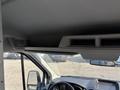 Interior view of a 2016 Ford Transit 150 showcasing the dashboard and front cabin area