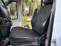 A black upholstered driver's seat of a 2019 Chevrolet Express showing contours and side support features