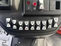 A control panel featuring various buttons for lights and mirrors including options for opening and closing features, fan speeds, and light settings
