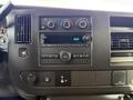 Dashboard of a 2023 GMC Savana featuring controls for air conditioning and audio system with a digital display showing the time 8143